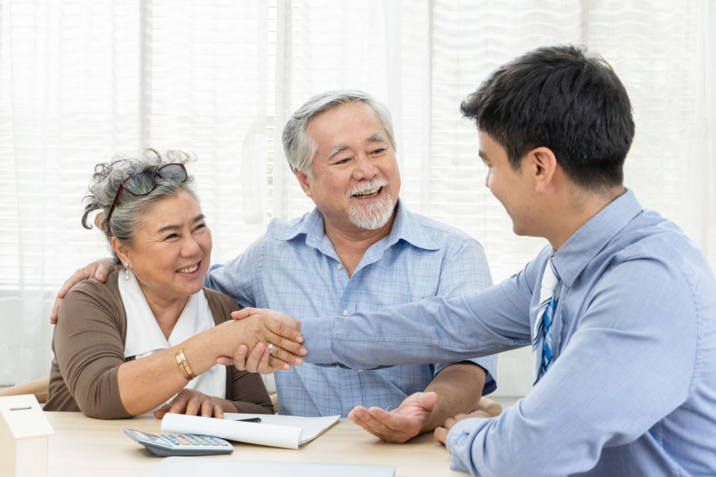 Elderly Couple, shaking hands with agent